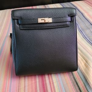 Leather backpack styled bag with turnlock closure.
